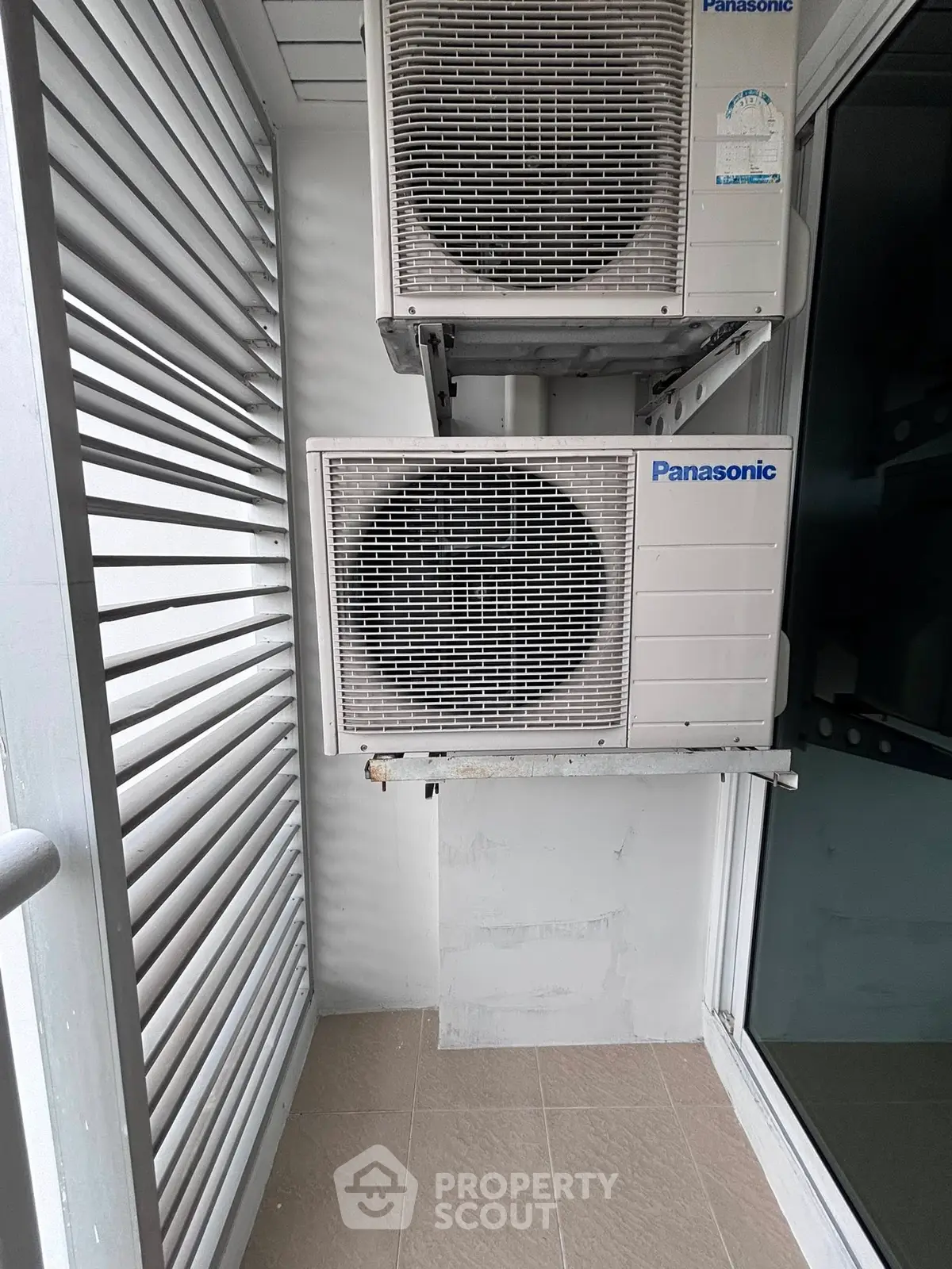 Compact balcony with air conditioning units in modern apartment