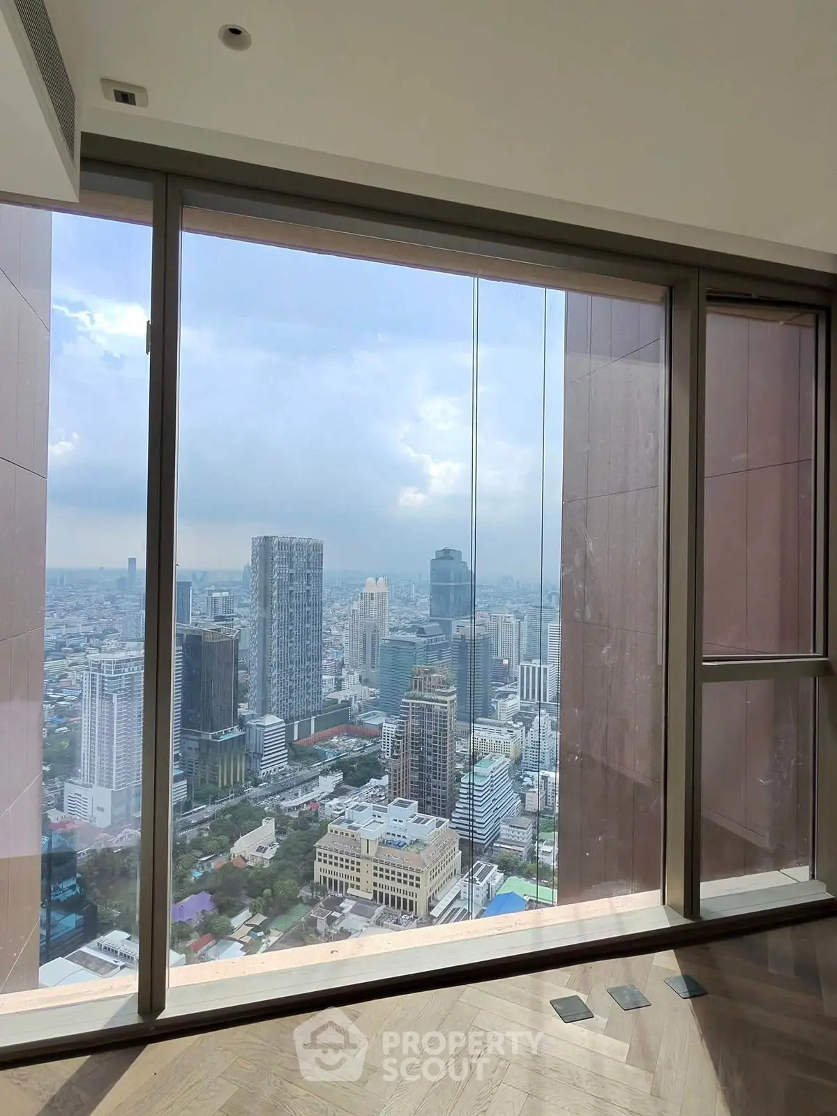 Stunning cityscape view from high-rise apartment window with modern design.