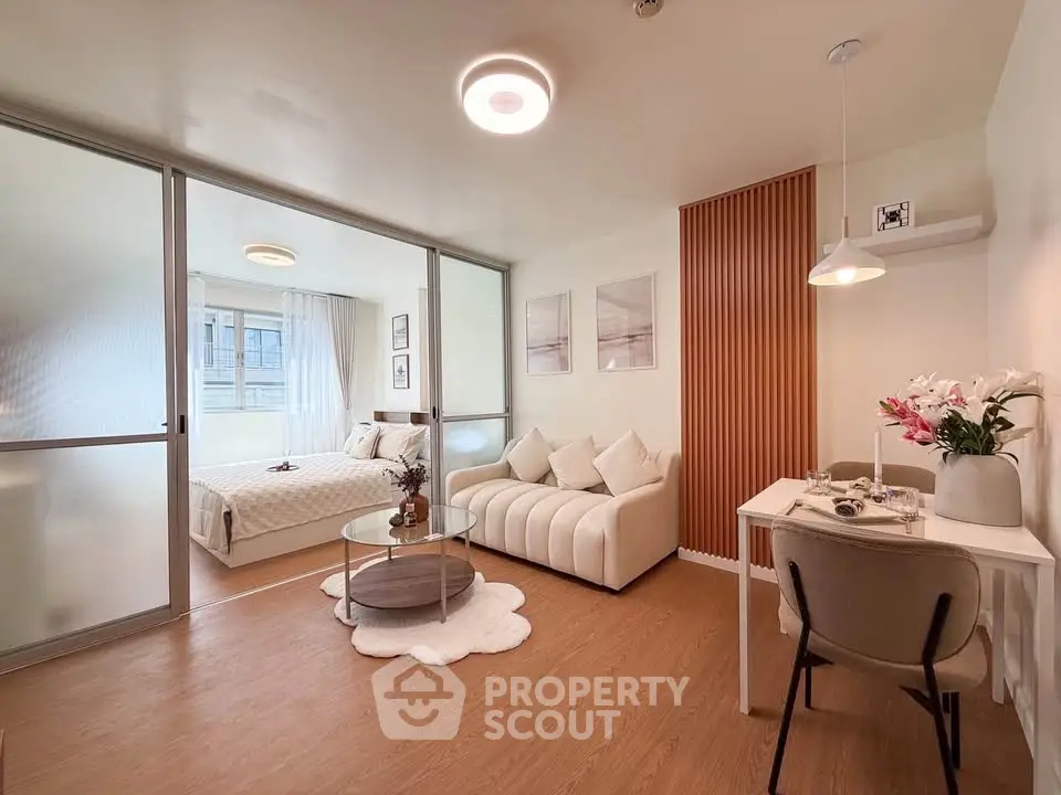 Modern studio apartment with open layout, featuring cozy living area and stylish bedroom.