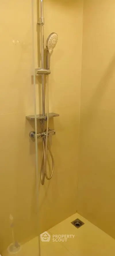 Modern bathroom shower with sleek fixtures and neutral tiles