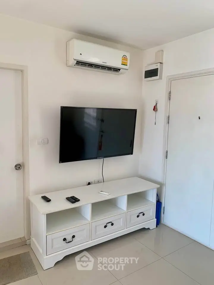 Modern living room with wall-mounted TV and air conditioning unit