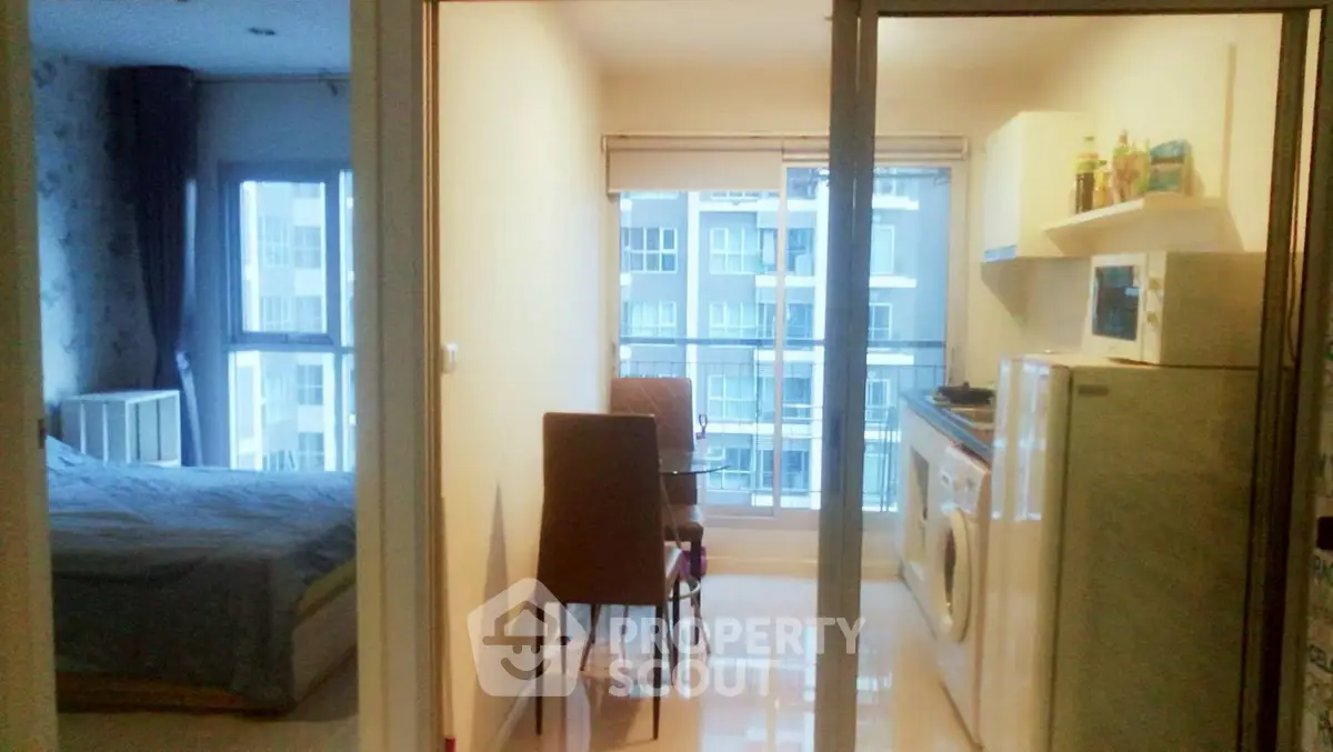 Cozy apartment with bedroom, kitchen, and city view, perfect for urban living.