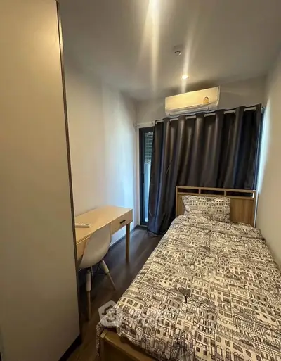 Cozy bedroom with single bed, study desk, and air conditioning