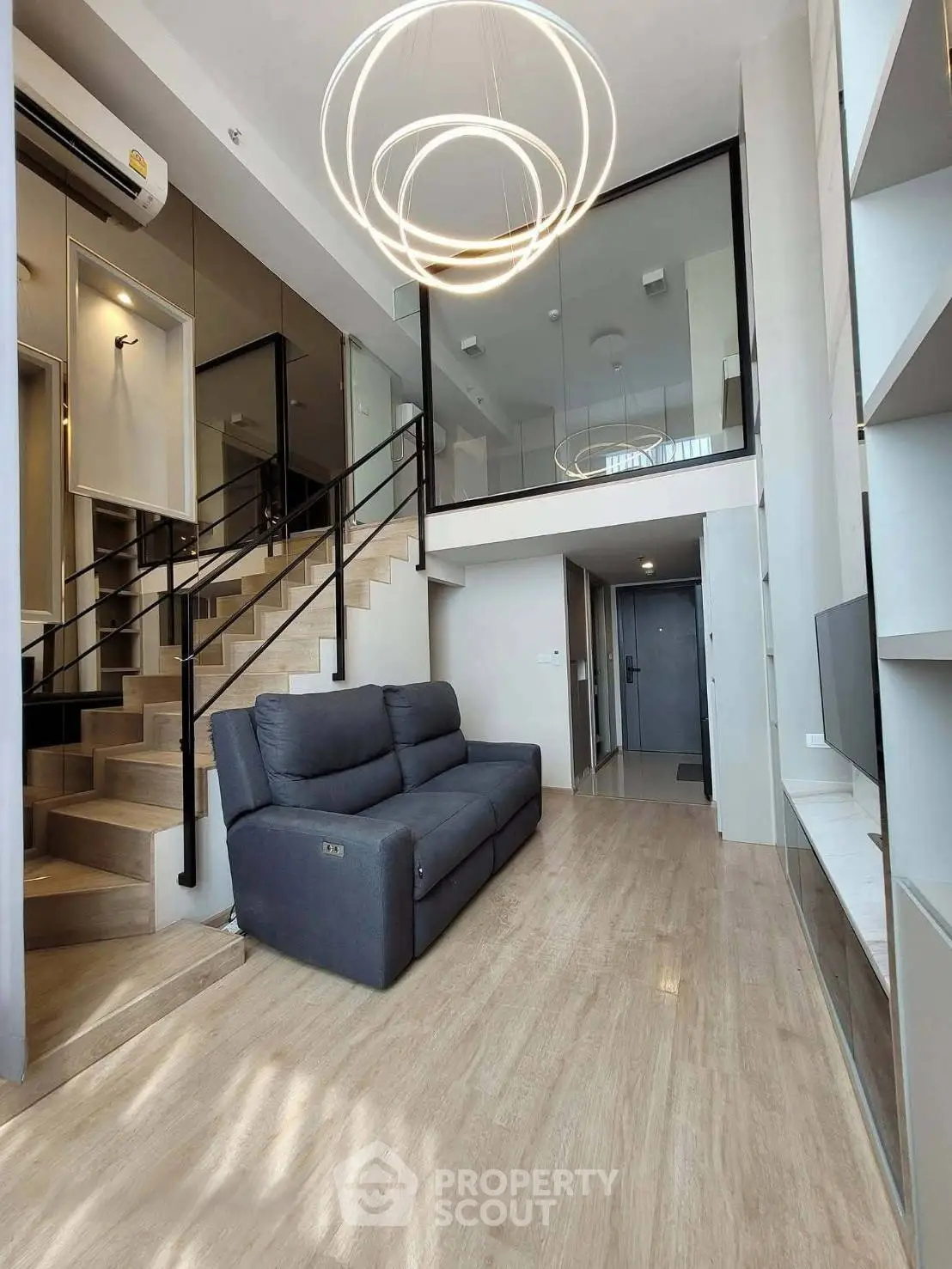 Modern duplex living room with stylish lighting and sleek staircase