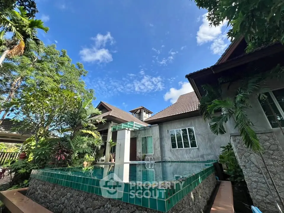 Stunning tropical villa with private pool and lush garden, perfect for luxurious living and relaxation.