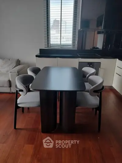 Modern dining area with sleek table and chairs in stylish apartment