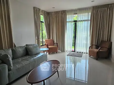 Spacious living room with elegant furniture and large windows for natural light.