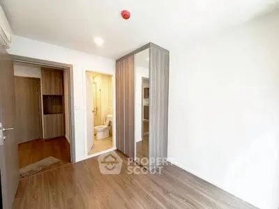 Modern bedroom with ensuite bathroom and wooden flooring