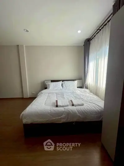 Cozy bedroom with natural light and modern decor