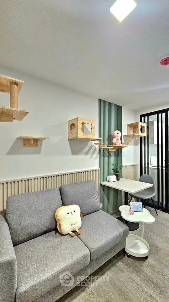 Modern living room with stylish cat shelves and cozy gray sofa