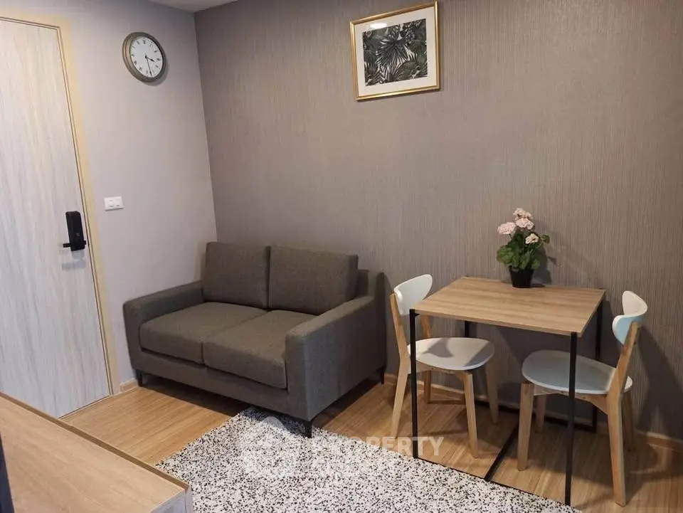 Cozy living room with modern sofa and dining set, perfect for small spaces.