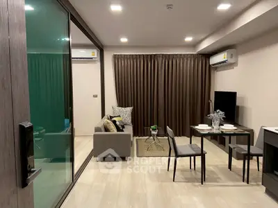 Modern living room with dining area and large glass sliding door in a stylish apartment.