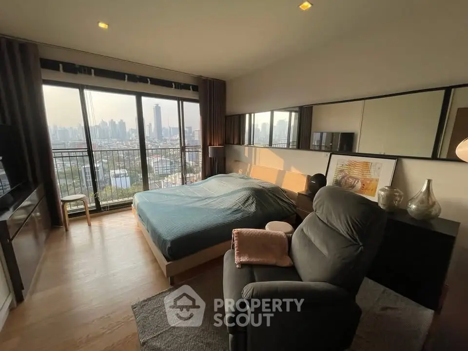 Luxurious bedroom with stunning city view and modern decor in high-rise apartment.