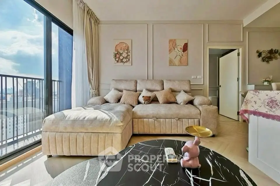 Luxurious living room with plush sofa and city view balcony, perfect for relaxation.