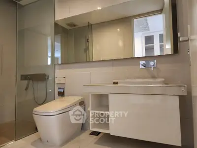 Modern bathroom with sleek fixtures and glass shower enclosure