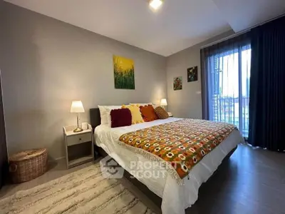 Cozy bedroom with stylish decor and large window for natural light