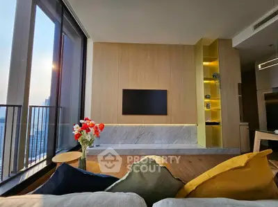 Modern living room with stylish decor and large windows offering stunning city views.