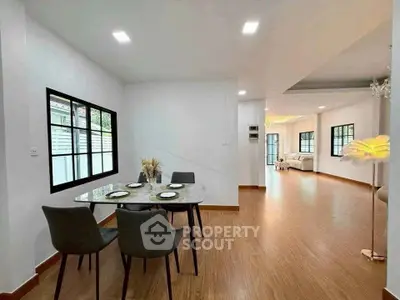 Spacious open-plan dining and living area with modern decor and natural light.