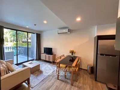 Spacious living room with modern decor and balcony view in a stylish apartment.