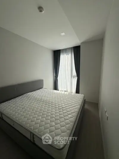 Spacious bedroom with natural light and modern decor