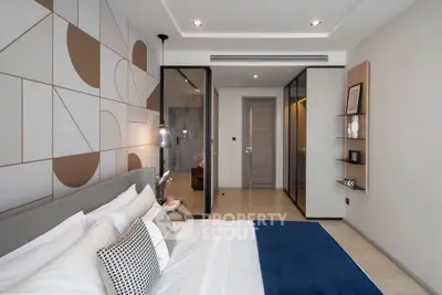 Modern bedroom with stylish decor and glass partition, featuring a cozy bed and elegant lighting.
