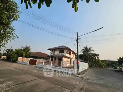 Charming two-story house with spacious yard and palm trees, perfect for family living in a serene neighborhood.