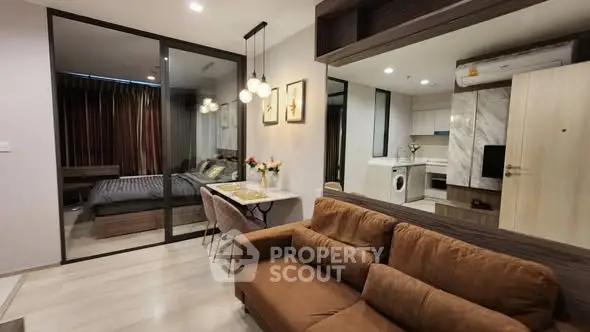 Modern open-plan living room with kitchen and bedroom in stylish apartment