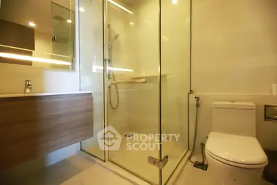 Modern bathroom with glass shower enclosure and sleek fixtures