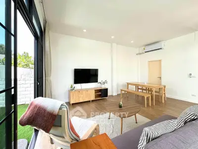 Spacious modern living room with large windows and stylish furniture