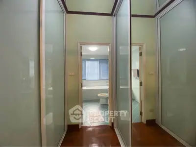Spacious bathroom with modern design and frosted glass doors