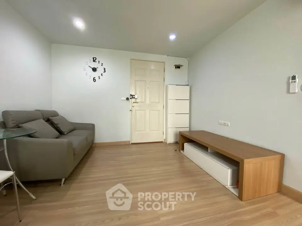 Modern living room with minimalist decor and stylish clock on wall