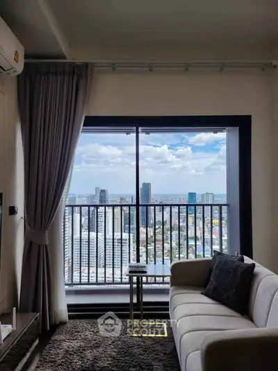 Modern living room with stunning city view from high-rise apartment balcony.