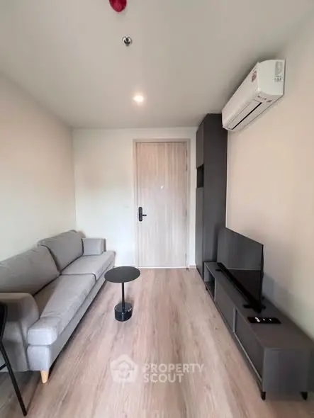 Modern living room with sleek furniture and air conditioning