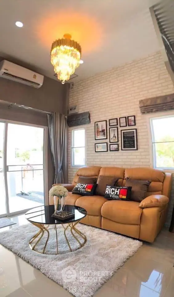 Luxurious living room with elegant chandelier and modern decor in a stylish apartment.