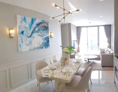 Elegant modern living room with stylish dining area and abstract art, featuring chic lighting and natural light.