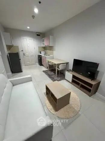 Modern living room with sleek furniture and open kitchen layout