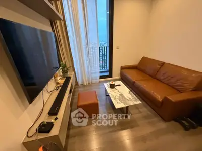Modern living room with leather sofa, wall-mounted TV, and city view from balcony.