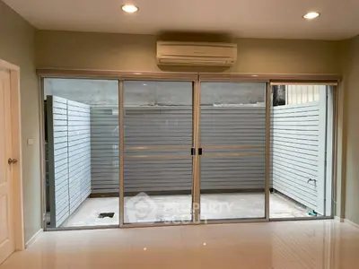 Modern interior with sliding glass doors leading to a private patio area.