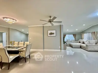 Spacious modern living and dining area with elegant furnishings and ceiling fan.