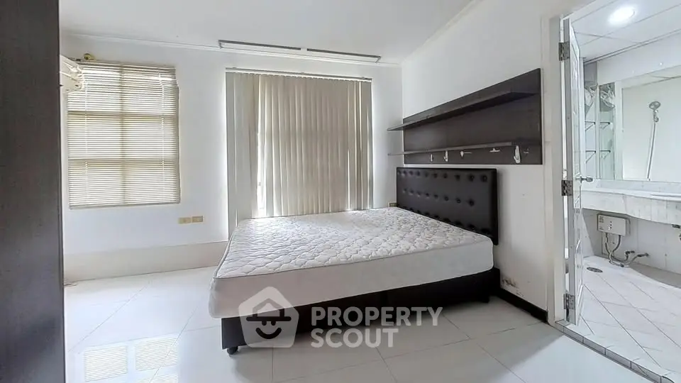 Spacious bedroom with modern design and ample natural light