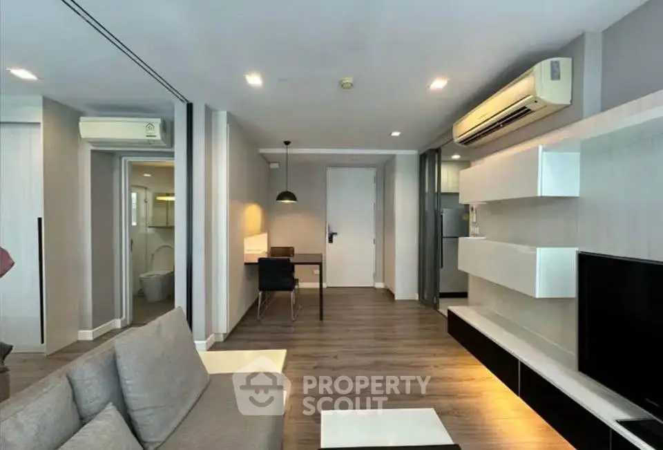 Modern living room with sleek furniture and air conditioning in a stylish apartment.