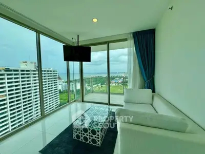 Stunning high-rise living room with panoramic city views and modern furnishings.