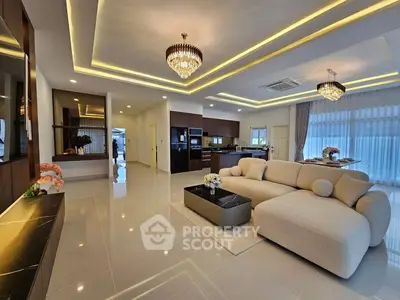 Luxurious open-plan living room with elegant lighting and modern furnishings.