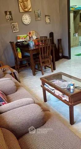 Cozy living room with wooden furniture and decorative wall art, perfect for relaxation.