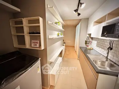 Modern kitchen with sleek design, featuring open shelving and built-in microwave, perfect for urban living.