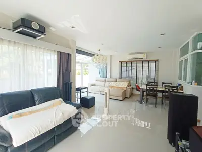 Spacious living room with elegant chandelier and modern furnishings