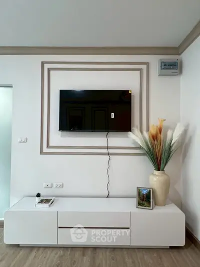 Modern living room with wall-mounted TV and stylish decor