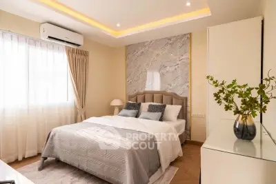 Luxurious bedroom with elegant decor and natural light, featuring a plush bed and stylish accents.