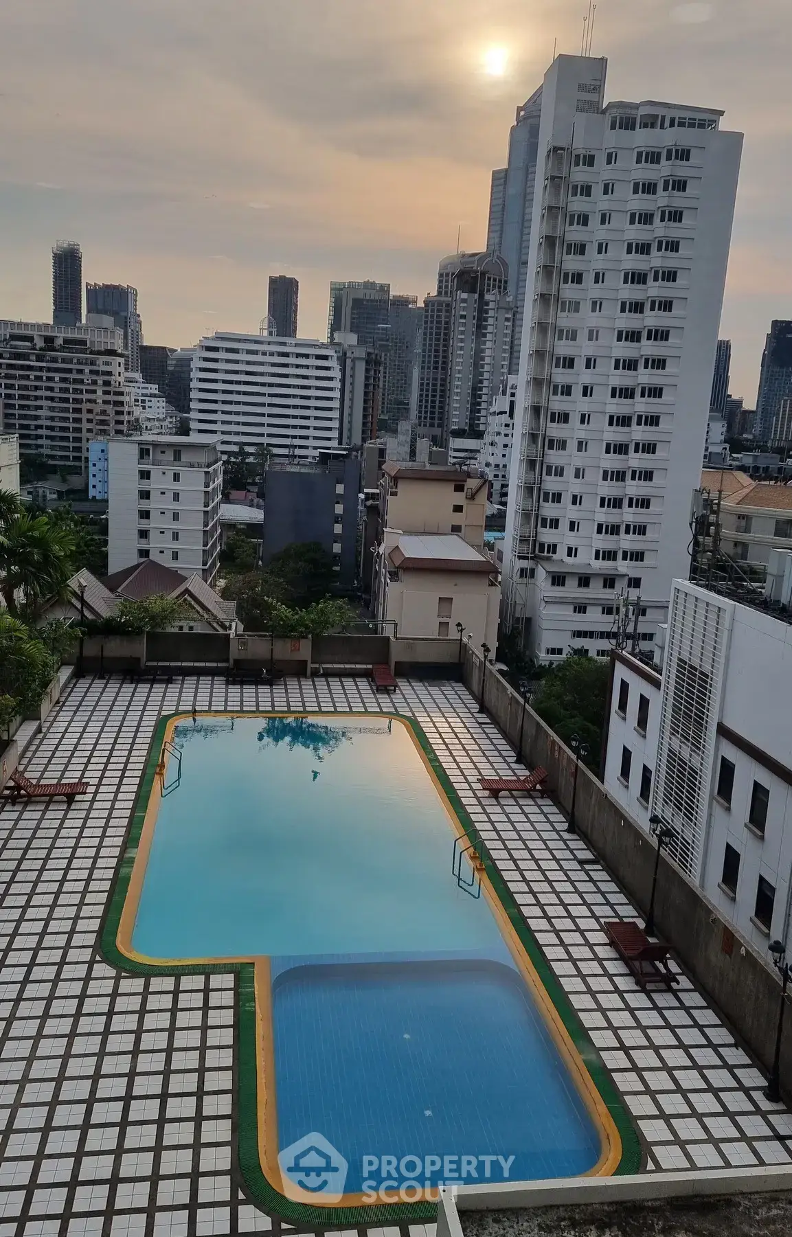 Stunning rooftop pool with city skyline views in a modern urban setting.