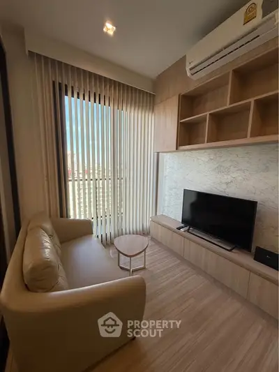 Modern living room with sleek design, featuring a cozy sofa, TV, and large window with city view.